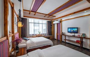 Krevet ili kreveti u jedinici u okviru objekta Zhangjiajie Highlights Guesthouse