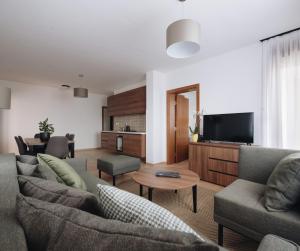 a living room with two couches and a tv at Pegaz Holiday Resort in Vrnjačka Banja