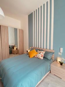 a bedroom with a blue bed with two pillows at Casa Antonietta in San Paolo Bel Sito