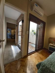 a hallway with a door to a room with a balcony at "Josefa" terraza y parrilla - Alojate Mendoza in Mendoza
