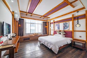 Krevet ili kreveti u jedinici u okviru objekta Zhangjiajie Highlights Guesthouse