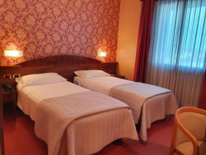 Postel nebo postele na pokoji v ubytování Hotel Poppi