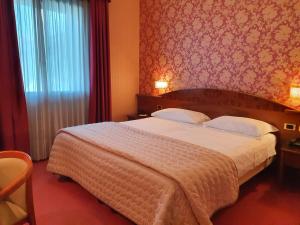 Postel nebo postele na pokoji v ubytování Hotel Poppi