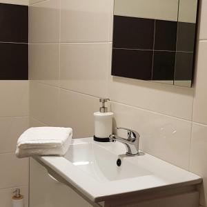 a bathroom with a white sink and a mirror at B Apartamentos in Viana do Castelo