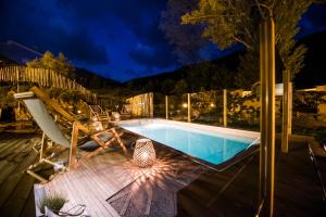 a swimming pool on a deck at night at Mountain Hostel Tarter in El Tarter