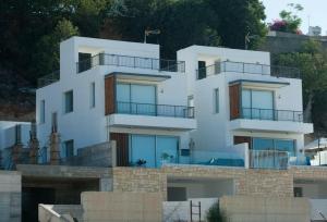 a white building with balconies on top of it at Leonidas VILLA in Paphos City