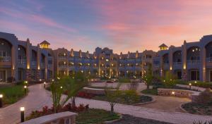 a rendering of the exterior of a resort at dusk at Lazuli Hotel, Marsa Alam in Quseir