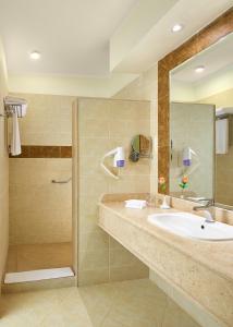 a bathroom with a sink and a shower at Lazuli Hotel, Marsa Alam in Quseir