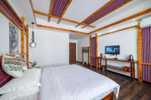 Krevet ili kreveti u jedinici u okviru objekta Zhangjiajie Highlights Guesthouse