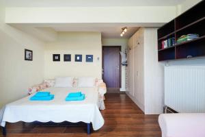 a bedroom with a bed with blue pillows on it at Giotas Sea View Apartment in Skala Kallirakhis