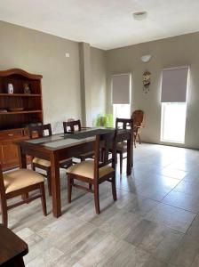 Un comedor con mesa y sillas de madera. en MORTERO II, en Cafayate 13 fotos más