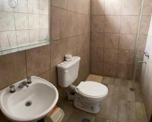 a bathroom with a toilet and a sink at MORTERO II in Cafayate