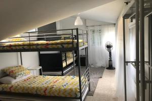 a room with three bunk beds and a television at Casa en plena naturaleza al lado del rio Verdugo in Arcade