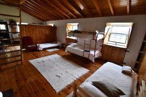 a room with two bunk beds and a window at Caldeira Guesthouse in Fajã da Caldeira de Santo Cristo