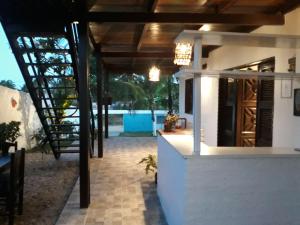a small house with a wooden ceiling and a staircase at Pousada Brisa Del Mar in Icaraí