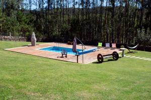 a swimming pool with a slide in a yard at Casal Rivas in Muxia
