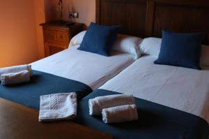 A bed or beds in a room at Casal Pedrajás