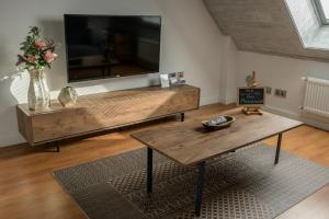 sala de estar con TV grande y mesa de madera en Dúplex a 25m del telecabina de La Massana (PAL) 644 en La Massana