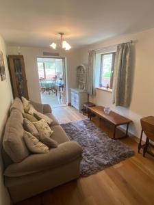 a living room with a couch and a table at Laurel Bank in Abbey-Cwmhir