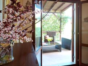 a vase with flowers on a table next to a glass door at The SeaSide Villas in Nikiti