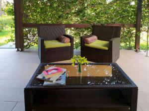 two chairs and a coffee table on a patio at The SeaSide Villas in Nikiti