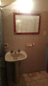 a bathroom with a sink and a mirror at Dpto PREMA in General Roca
