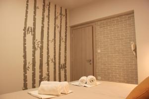 a bathroom with two towels and a brick wall at House Ekton in Pefkari