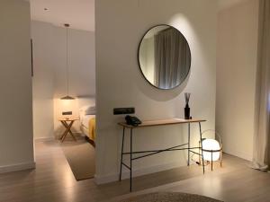 a room with a table and a mirror and a bed at Hotel Avenida in Zaragoza