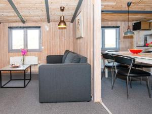 a living room with a couch and a table at 6 person holiday home in Fan in Fanø