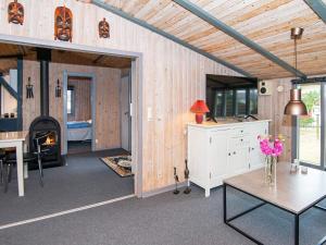 a living room with a table and a fireplace at 6 person holiday home in Fan in Fanø