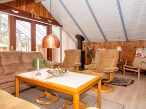 a living room with a table and chairs at 5 person holiday home in R m in Bolilmark