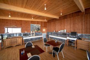 a room with wooden walls and wooden tables and chairs at Hotel Breidavik in Breiðavík