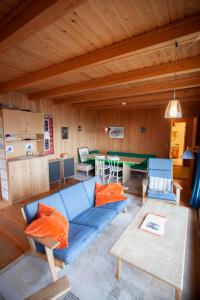 BøurにあるIdyllic Vacation Home with a Breathtaking Viewのリビングルーム(青いソファ、テーブル付)
