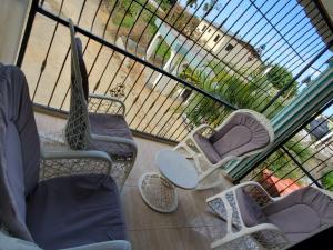 a view of a balcony with chairs and a window at Oasis de Paz 3 in Jarabacoa