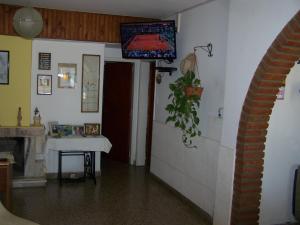 a room with a table and a television on the wall at Aloha in Villa Carlos Paz