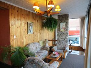 a living room with two couches and a ceiling fan at Hotel Ritz in Villa Carlos Paz