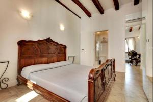 a bedroom with a wooden bed in a room at Venice traditional home with terrace in Venice