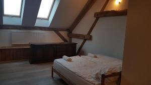a bedroom with a bed in a attic at Dziewanna in Brzeziniec +47 photos