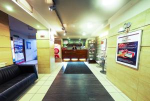 a lobby of a store with a couch and a bar at Hotel Diament Economy Gliwice in Gliwice