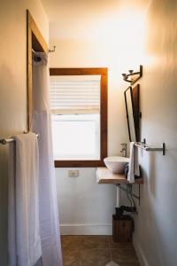 a bathroom with a white shower curtain and a sink at Left Coast Lodge - Pet Friendly in Sisters