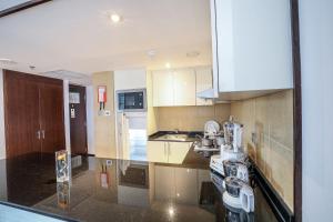 a kitchen with a sink and a counter top at Copthorne Downtown by Millennium in Abu Dhabi