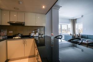 a kitchen with a black counter top in a room at Copthorne Downtown by Millennium in Abu Dhabi