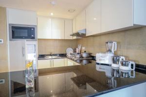 a kitchen with a counter with a mixer on it at Copthorne Downtown by Millennium in Abu Dhabi