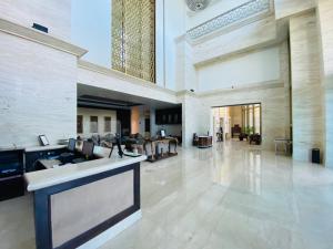 a large lobby of a building with a bar in it at Seven Seas Hotel in New Delhi