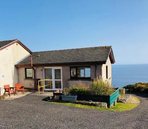 a small house with a view of the ocean at The Stroops in Helmsdale