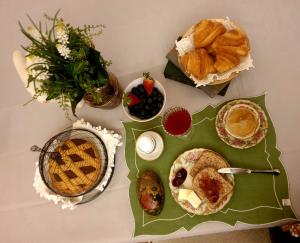 a table with pastries and other foods on it at Antica Casa Zucchini B&B in Bologna