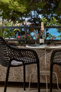 een tafel met twee glazen en een fles wijn erop bij Apartment Mucrum in Makarska