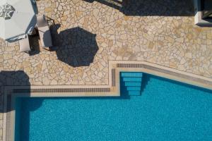 an overhead view of a swimming pool in a house at Tramonto Suites in Xi