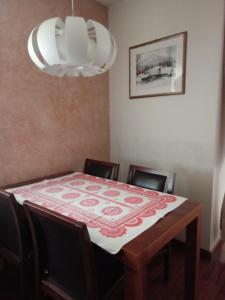 a dining room with a table and chairs and a chandelier at APARTAMENT LUCYNA in Rabka-Zdrój