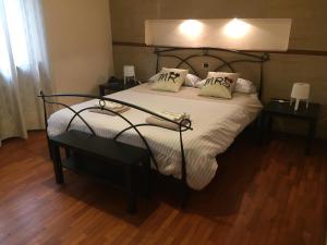 a bedroom with a large bed with two night stands at La Villa Del Cedro in Monza